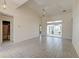 Open living room with tiled floors, ceiling fan, and sliding glass doors to the backyard at 81 Safe Harbor Ave., Pawleys Island, SC 29585