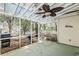 Relaxing screened porch with ceiling fan, grill, and view of the fenced backyard at 81 Safe Harbor Ave., Pawleys Island, SC 29585