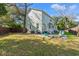 Lush backyard featuring a fire pit area and a tree providing plenty of shade at 837 Flicker Pl., Murrells Inlet, SC 29576