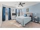 Bright bedroom with queen bed, blue accent wall, and coastal decor at 837 Flicker Pl., Murrells Inlet, SC 29576
