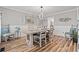 Dining room with a stylish table set for six, modern lighting, and tasteful decor at 837 Flicker Pl., Murrells Inlet, SC 29576