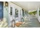 Inviting front porch with rocking chairs, lantern decor, and a 'Welcome' mat at 837 Flicker Pl., Murrells Inlet, SC 29576