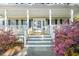 Inviting covered porch with detailed trim and beautiful plants at the entrance to the home at 837 Flicker Pl., Murrells Inlet, SC 29576
