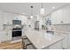 Bright kitchen featuring white cabinets, granite countertops, a kitchen island, and stainless steel appliances at 837 Flicker Pl., Murrells Inlet, SC 29576