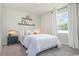Bright bedroom features soft carpeting, comfortable bed, large window and stylish decor at 886 Farmers Passage Loop, Loris, SC 29569