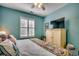 Bright bedroom featuring an accent wall, ceiling fan, and a TV on a stylish dresser at 901 West Port Dr. # 2101, North Myrtle Beach, SC 29582