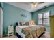 Comfortable bedroom featuring an accent wall, ceiling fan and bright, natural light at 901 West Port Dr. # 2101, North Myrtle Beach, SC 29582