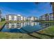 Beautiful community buildings with a pond, water fountain, grassy landscape, and clear sky at 901 West Port Dr. # 2101, North Myrtle Beach, SC 29582