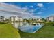 Beautiful community buildings with a pond, water fountain, and grassy landscape, and clear sky at 901 West Port Dr. # 2101, North Myrtle Beach, SC 29582