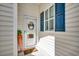 Charming condo front door with welcome decor, side window, and blue shutters at 901 West Port Dr. # 2101, North Myrtle Beach, SC 29582