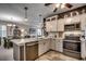 Open-concept kitchen featuring stainless steel appliances, white cabinets, and an island at 901 West Port Dr. # 2101, North Myrtle Beach, SC 29582