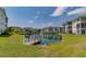 Scenic community pond and wooden dock surrounded by grassy landscape and community buildings at 901 West Port Dr. # 2101, North Myrtle Beach, SC 29582