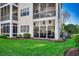 Exterior view of a sunroom addition with large windows overlooking a well-maintained lawn at 901 West Port Dr. # 2101, North Myrtle Beach, SC 29582
