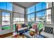 Bright sunroom features comfortable seating and large windows, offering views of the neighborhood at 901 West Port Dr. # 2101, North Myrtle Beach, SC 29582