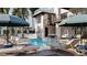 Relaxing pool area with lounge chairs, umbrellas, a small waterfall, and hanging swing chairs at 918 Strand Ave., North Myrtle Beach, SC 29582