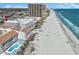 Stunning coastal view of the beachfront condos with a large sandy beach and a pier at 9580 Shore Dr. # 311, Myrtle Beach, SC 29572