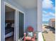 Charming balcony with a chair, table, and ocean view, accessible through a sliding glass door from the bedroom at 9580 Shore Dr. # 311, Myrtle Beach, SC 29572