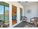 Relaxing balcony with outdoor seating and a glimpse of the living room through a sliding glass door at 9580 Shore Dr. # 311, Myrtle Beach, SC 29572