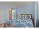 Cozy bedroom featuring a patterned bedspread, a window with blinds, and a door to another room at 9580 Shore Dr. # 311, Myrtle Beach, SC 29572
