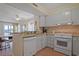 Efficient kitchen featuring white cabinets and views to the living room at 9580 Shore Dr. # 311, Myrtle Beach, SC 29572