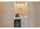 Convenient wet bar with a wine cooler, sink, storage cabinet, and a decorative backsplash at 9580 Shore Dr. # 311, Myrtle Beach, SC 29572