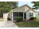 Charming single-story home featuring a screened front porch and well-maintained landscaping at 9972 Conifer Ln., Murrells Inlet, SC 29576