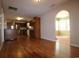 Open-concept living area with hardwood floors leading into the kitchen and sunroom at 9972 Conifer Ln., Murrells Inlet, SC 29576