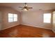 Large living area with hardwood floors, fan, and natural light through multiple windows at 9972 Conifer Ln., Murrells Inlet, SC 29576