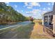 Tranquil backyard with a view of the pond and a well-maintained lawn, plus screened porch at 1112 Raven Cliff Ct., Conway, SC 29526