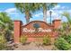 Elegant brick community sign with palm trees, representing the neighborhood's identity and welcoming entrance at 1112 Raven Cliff Ct., Conway, SC 29526