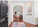 Inviting foyer with hardwood floors, arched doorway to the living room and decorative wall niche at 1112 Raven Cliff Ct., Conway, SC 29526