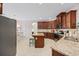 Spacious kitchen with granite counters, stainless steel appliances, and a breakfast bar overlooking the dining area at 1112 Raven Cliff Ct., Conway, SC 29526