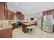 Open kitchen featuring granite countertops, stainless appliances, tile backsplash, and a center island with seating at 1112 Raven Cliff Ct., Conway, SC 29526