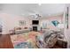 Bright living room featuring a fireplace, ceiling fan, and a colorful accent rug at 1112 Raven Cliff Ct., Conway, SC 29526