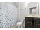 Well-maintained bathroom featuring a vanity with dark wood cabinets and a shower with floral curtain at 1130 Inlet View Dr., North Myrtle Beach, SC 29582
