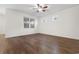 A bright bedroom with hardwood floors, a ceiling fan and natural light from the window at 1130 Inlet View Dr., North Myrtle Beach, SC 29582