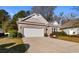 Charming single-story home featuring a brick facade, a two-car garage, and well-maintained landscaping at 1130 Inlet View Dr., North Myrtle Beach, SC 29582