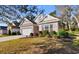 Charming single-story home featuring a brick facade, a two-car garage, and well-maintained landscaping at 1130 Inlet View Dr., North Myrtle Beach, SC 29582