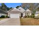 Charming single-story home featuring a brick facade, a two-car garage, and well-maintained landscaping at 1130 Inlet View Dr., North Myrtle Beach, SC 29582