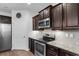 Kitchen boasts stainless steel appliances, granite countertops, white backsplash, and dark wood cabinets at 1130 Inlet View Dr., North Myrtle Beach, SC 29582