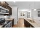 Spacious kitchen with granite countertops, stainless steel appliances, dark wood cabinets, and an island at 1130 Inlet View Dr., North Myrtle Beach, SC 29582