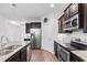 Modern kitchen featuring stainless steel appliances, granite countertops, dark wood cabinets, and an island at 1130 Inlet View Dr., North Myrtle Beach, SC 29582