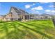 Expansive backyard featuring lush green grass, screened porch, patio with grill, and a privacy fence at 329 Lake Mist Ct., Longs, SC 29568