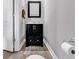 Powder room with modern vanity, wood-look flooring, and neutral color scheme at 329 Lake Mist Ct., Longs, SC 29568