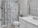 Cozy bathroom features a seashell-themed shower curtain and a white vanity with chrome hardware at 329 Lake Mist Ct., Longs, SC 29568