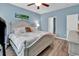 Comfortable bedroom featuring stylish nautical decor, wood flooring, and abundant natural light at 329 Lake Mist Ct., Longs, SC 29568