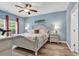 Inviting bedroom with soothing blue walls, ceiling fan, and natural light from the window at 329 Lake Mist Ct., Longs, SC 29568