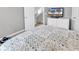 Comfortable bedroom featuring a patterned quilt, white dresser and a TV screen with palm trees at 329 Lake Mist Ct., Longs, SC 29568