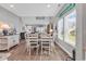 Open dining area with coastal decor, lots of natural light, and wood-look flooring at 329 Lake Mist Ct., Longs, SC 29568