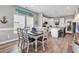 Dining room features coastal decor, natural light, and wood-look flooring at 329 Lake Mist Ct., Longs, SC 29568